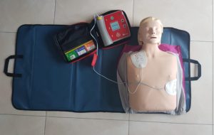 male mannequin attached to AED trainer
